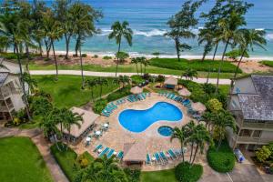 an aerial view of a resort with a swimming pool and the ocean at Aston Islander On The Beach in Kapaa