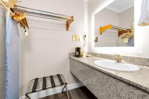 a bathroom with a sink and a mirror at SureStay by Best Western San Francisco Marina District in San Francisco