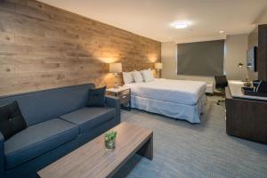 a hotel room with a bed and a flat screen tv at The Row Hotel; BW Signature Collection in San Jose