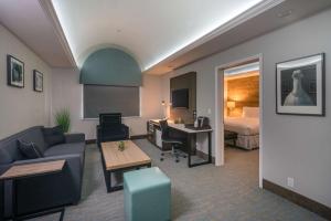 a hotel room with a couch and a bed at The Row Hotel; BW Signature Collection in San Jose +15 photos