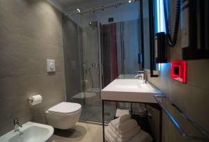 a bathroom with a sink and a toilet and a shower at Best Western Plus Sabaudia Hotel in Sabaudia