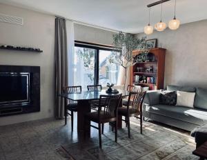 a living room with a table and chairs and a couch at Apartments "Lichtenstein Valley" in Unterhausen