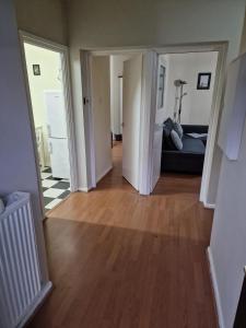 an empty living room with a couch and wooden floors at Waterloo - Zone 1 - Spacious one bedroom flat in London