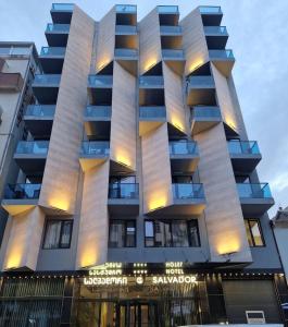 a building with balconies on the side of it at Hotel Salvador in Batumi