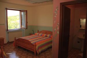 Postel nebo postele na pokoji v ubytování Agriturismo La Praduscella