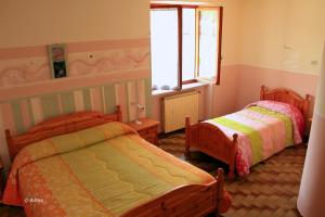 Postel nebo postele na pokoji v ubytování Agriturismo La Praduscella