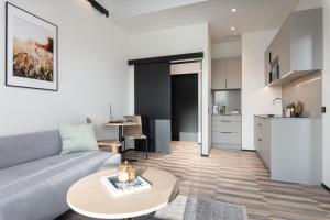 a living room with a couch and a table at Väo Keskus Modern Guest Apartments in Tallinn