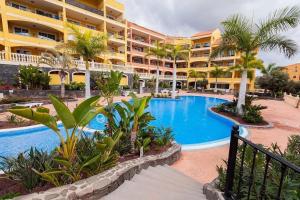 a resort with a swimming pool in front of a building at Casa Louise te Palm - Mar in Palm-Mar