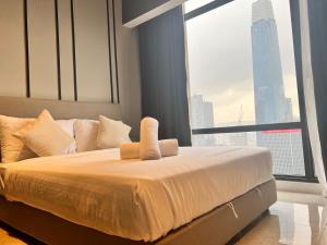 a bed in a room with a large window at The Axon Bukit Bintang By Cozy White in Kuala Lumpur