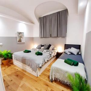 a bedroom with two beds and a window at Casa Bracco in Turin