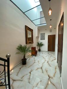 a hallway with a large marble floor and a mirror at Riad Jbara 2 in Rabat
