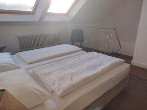 two white beds in a room with a window at Hotel Friederike in Mülheim an der Ruhr