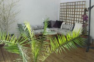 a living room with a couch and some plants at Roós, design loft near the sea. in Barcelona