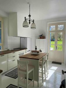 a kitchen with a table and chairs in a kitchen at Charming holiday home in a beautiful setting in Axat
