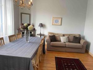 a living room with a table and a couch at Charming holiday home in a beautiful setting in Axat