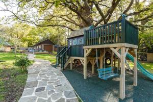 a large playground with a slide in a yard at The Stables - 2 bed with large garden and hot tub. in Sway