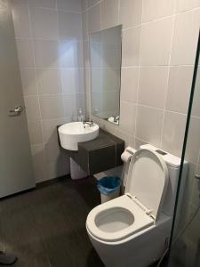 a bathroom with a white toilet and a sink at Evo Soho in Bandar Baru Bangi