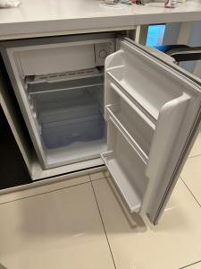 an empty refrigerator with its door open in a kitchen at Evo Soho in Bandar Baru Bangi
