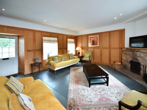 a living room with a couch and a fireplace at Cloncaird Castle Estate Cottages in Maybole