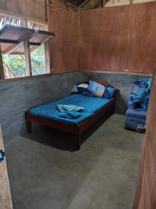 a bedroom with a bed with a blue comforter at Dream house 
