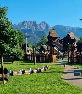 a group of people laying on the grass in a park at Sunny Apartment Centrum Zakopane in Zakopane