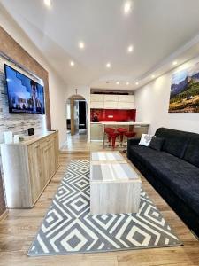 a living room with a couch and a table at Sunny Apartment Centrum Zakopane in Zakopane