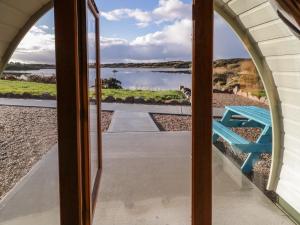 a window view of a lake from a house at The Wheelhouse Pod No 6 in Letterkenny +8 photos