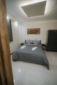 a bedroom with a bed with two towels on it at Panorama Apartment in Kozani