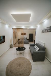 a living room with a couch and a table at Panorama Apartment in Kozani