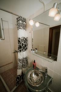 a bathroom with a sink and a mirror at Panorama Apartment in Kozani