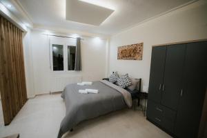 a bedroom with a bed with two towels on it at Panorama Apartment in Kozani