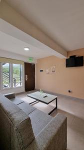 a living room with a couch and a table at Robinson Alojamientos - Edificio Erico Orlando in Ushuaia