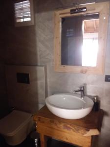 a bathroom with a white sink and a mirror at Esila bungalow sea and nature wiev in Fethiye