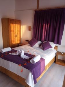 a bedroom with a bed with a doll on it at Esila bungalow sea and nature wiev in Fethiye