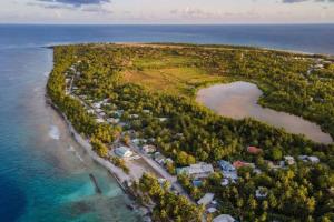 an aerial view of a small island in the ocean at Dive Residence - Fuvahmulah, Maldives in Fuvahmulah