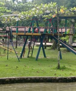 a playground with a slide in a park at Traillertuba Yaveh in Ubatuba