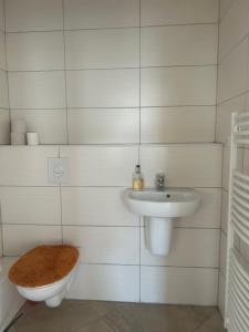 a bathroom with a toilet and a sink at Urban Escape Haven in Hannover