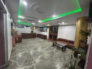 a lobby with a waiting room with couches and a green light at Hotel Maurya Vihar Bodhgaya in Bodh Gaya +43 photos