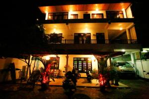 a house at night with lights in front of it at New Ocean Vibes in Weligama