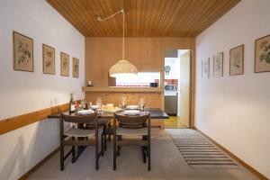 a kitchen and dining room with a table and chairs at Brentschpark Wohnung 72 in Scuol