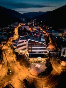 a large building in a city at night at Hotel International in Sinaia