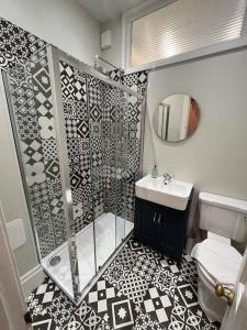 a bathroom with a shower and a sink at Beautifully Renovated 2 Bedroom Apartment in Stirling +25 photos