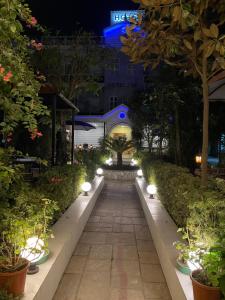 a pathway with lights in a garden at night at Hotel ABC, Boutique Hotel in Pokhara in Pokhara