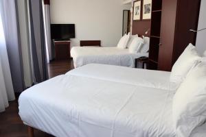 Postel nebo postele na pokoji v ubytování Hôtel Du Centre Annemasse