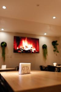 a fire painting on the wall of a room at San Pedro Hotel & Restó in San Pedro