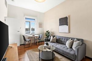 a living room with a couch and a table at Balmain Wharf 1 bedroom Apartments in Sydney