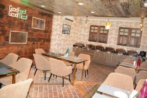 a restaurant with tables and chairs and a bar at Hotel Green Rooms, Vintage Luxury Near Dal Lake in Srinagar