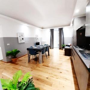 Casa Bracco في تورينو: مطبخ وغرفة طعام مع طاولة وكراسي