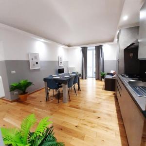 a kitchen and dining room with a table and chairs at Casa Bracco in Turin