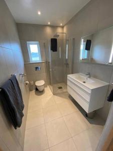 y baño con lavabo, ducha y aseo. en Family Wildlife Experience 3 BR House, en Uddevalla